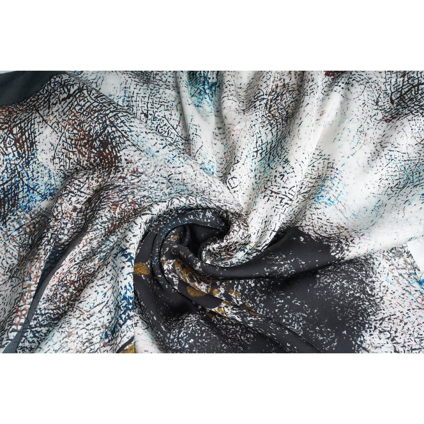 A medium size model draped in an organic rose petal silk fabric scarf, printed with non toxic GOTS certified inks. the scarf has a printed of hazy fields with leaves and flowers flying.