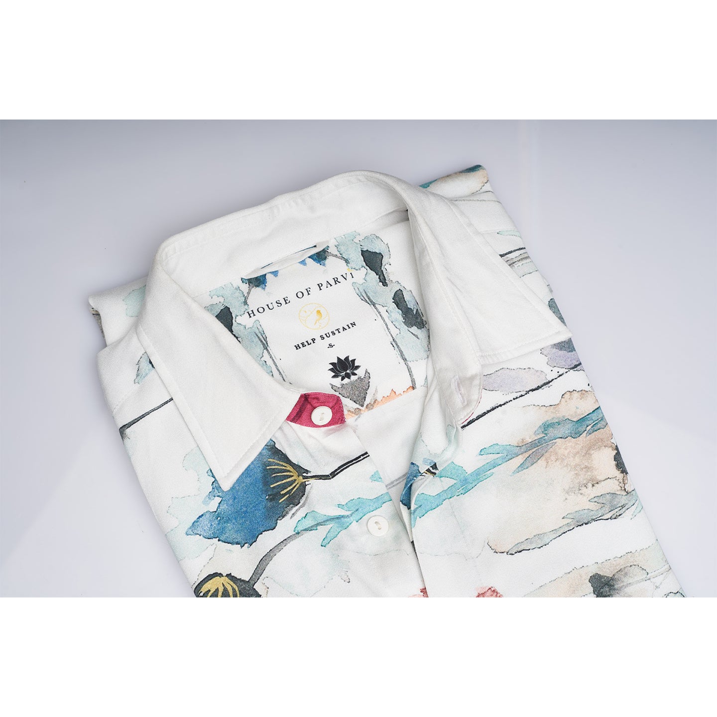 The printed WHITE floral organic lotus fabric shirt offers an interpretation of a timeless piece with a modern take. Made from a soft lotus stem silk fabric, It displays a comfortable fit and a rounded curved hemline featuring a placement floral pattern with one sleeve in solid and other sleeves in print, inspired by the wilderness