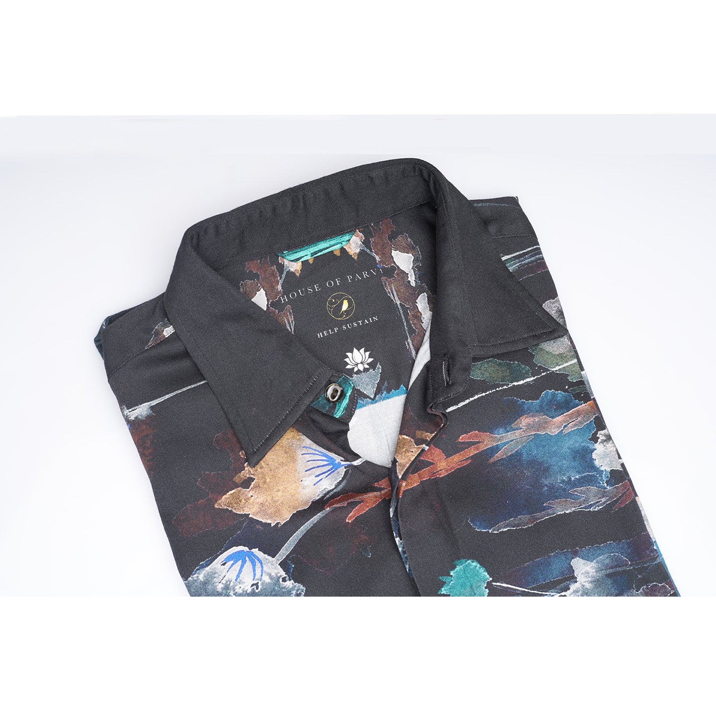 The printed Black floral organic lotus fabric shirt offers an interpretation of a timeless piece with a modern take. Made from a soft lotus stem silk fabric, It displays a comfortable fit and a rounded curved hemline featuring a placement floral pattern with one sleeve in solid and other sleeves in print, inspired by the wilderness