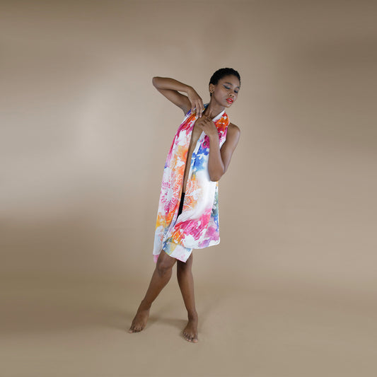 a woman draped in a colorful scarf made from organic rose petal fabric scarf