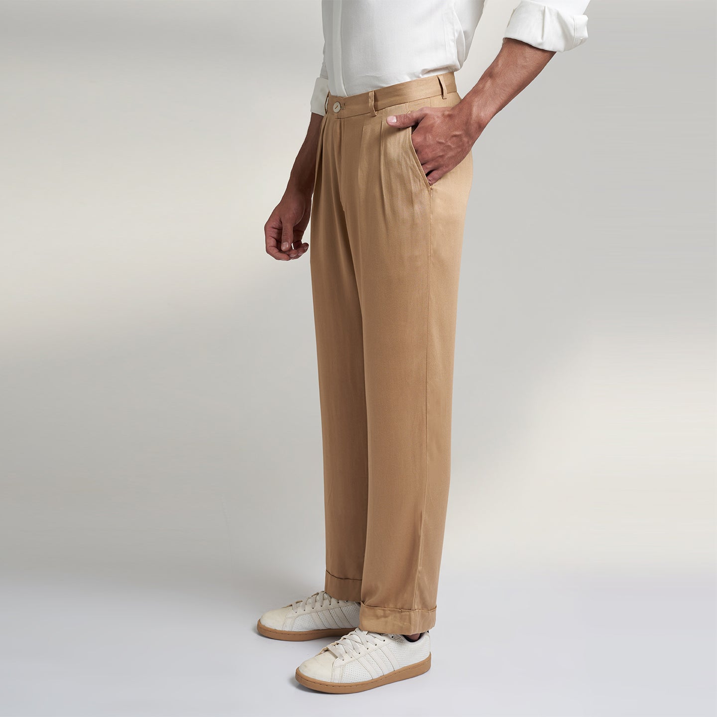 a medium size model wearing beige color trouser made from organic lotus silk fabric. the pant is a basic straight fit with 2 pleats and turn up bottom. 