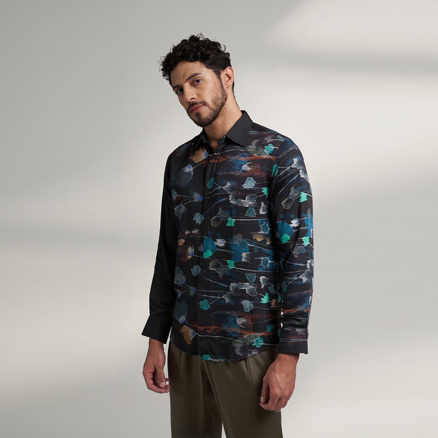 The printed Black floral organic lotus fabric shirt offers an interpretation of a timeless piece with a modern take. Made from a soft lotus stem silk fabric, It displays a comfortable fit and a rounded curved hemline featuring a placement floral pattern with one sleeve in solid and other sleeves in print, inspired by the  wilderness