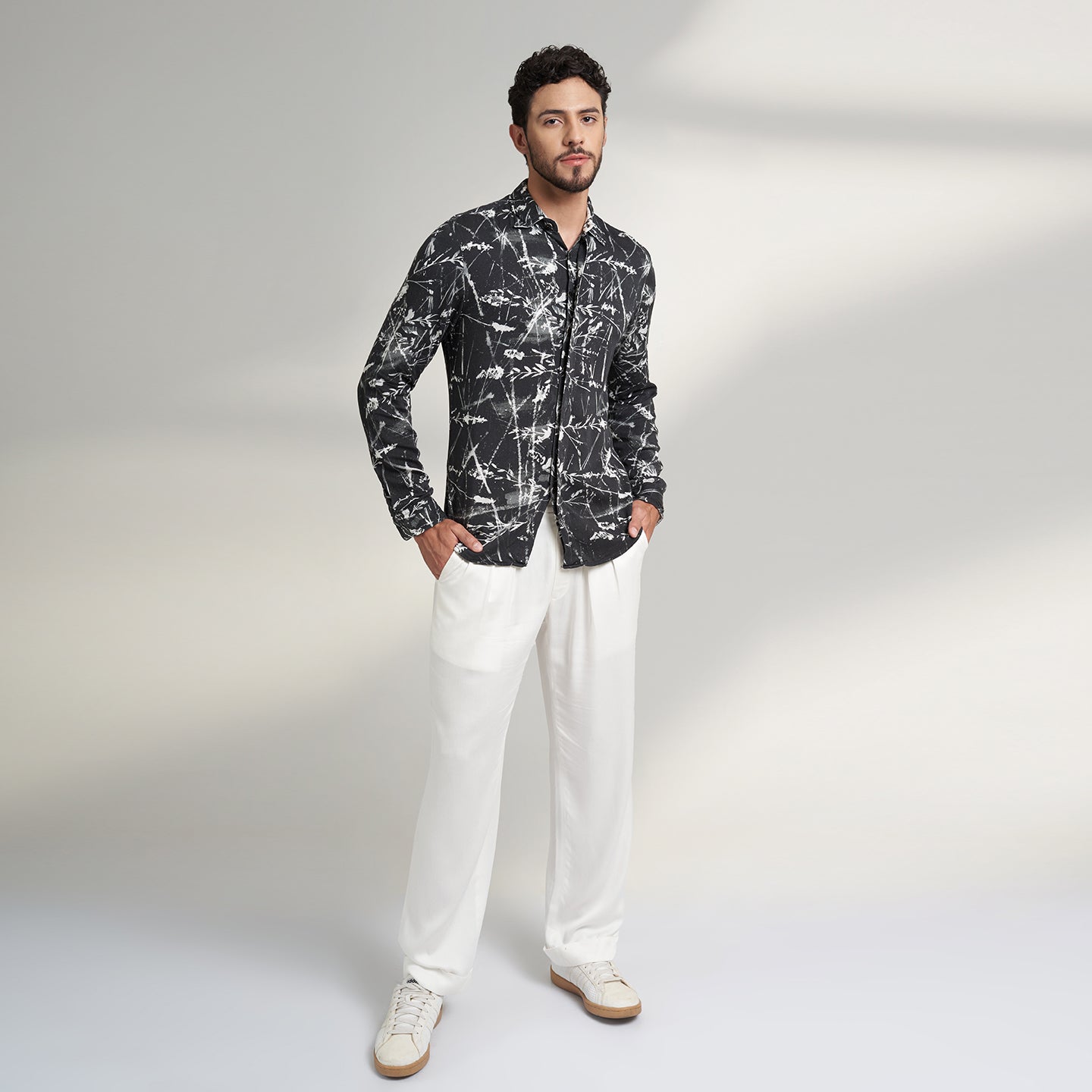 Organic lotus stem fabric printed shirt in black and white leafy print. the shirt has round bottom hem with a comfort fit